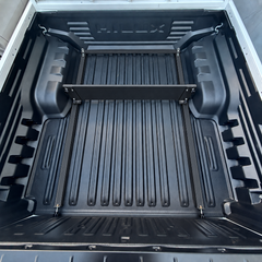 Black wheel arch divider fitted between the
wheel arch of a ute tub