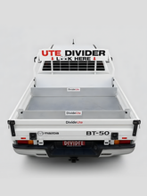 White truck bed with 'Divide Ute' branding and text on a white background