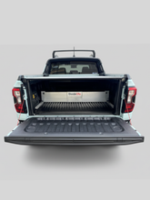Open truck bed with a tonneau cover and a TubDivider