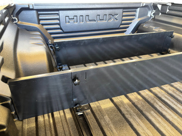 No-drill TubDivider adjustment bracket inside Toyota HiLux factory tub liner