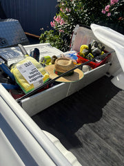 Tub divider separating shopping and
loose household items in a ute tub