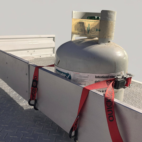 Gas cylinder held with a red strap beside
an aluminium tray divider