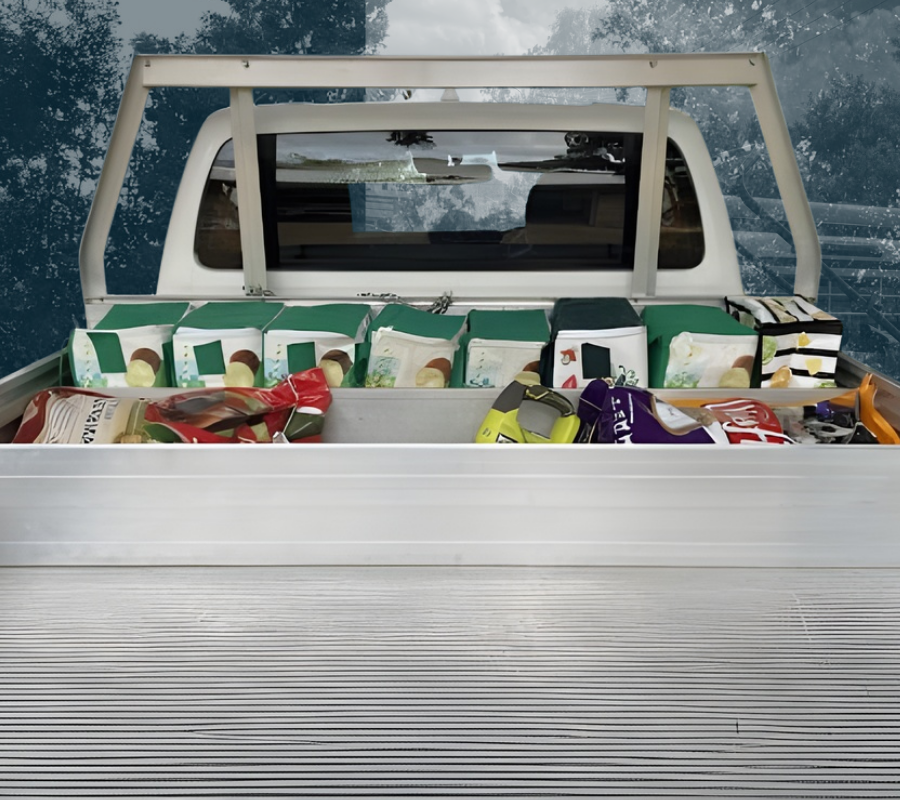 Tray of a vehicle filled with various shopping contained by a TrayDivider
